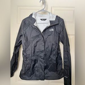 Woman’s black north face rain jacket.